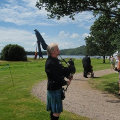 A man playing bag pipes at Loch Lomond