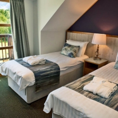 A twin bedroom in a lodge at Loch Lomond Waterfront