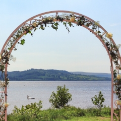 A wedding arch with views of Loch Lomond in front of it