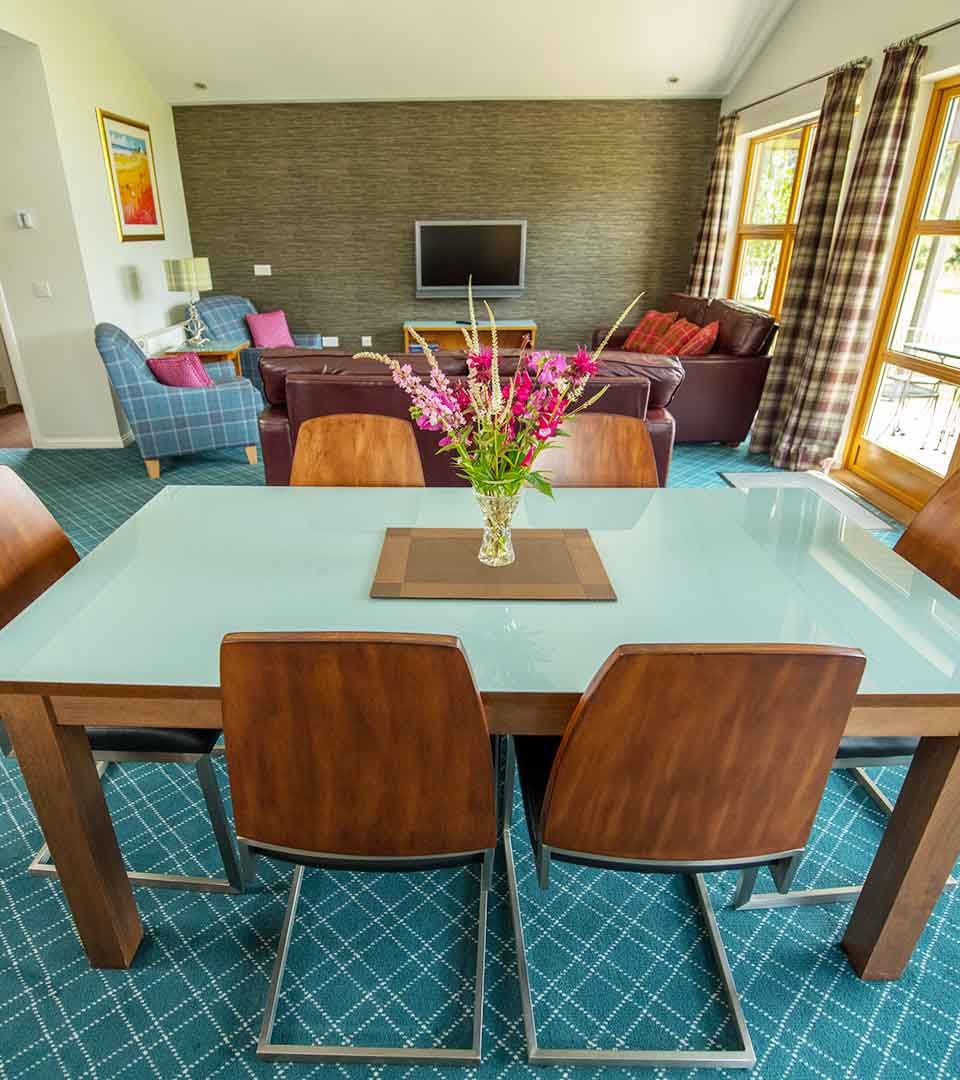 The dining and living area in a Chalet at Loch Lomond Waterfront