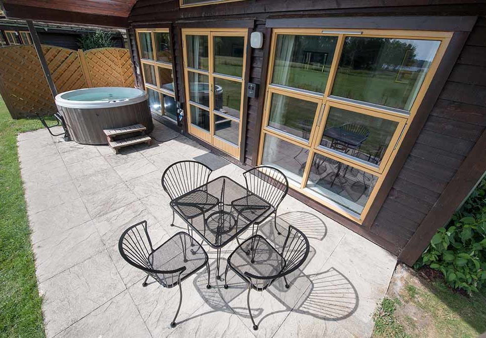 An outdoor seating area with hot tub at Loch Lomond Waterfront