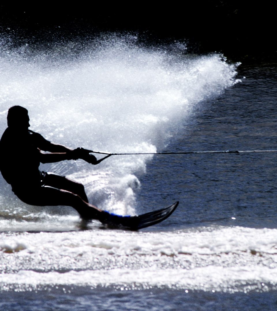 Silhouette of a man water skiing