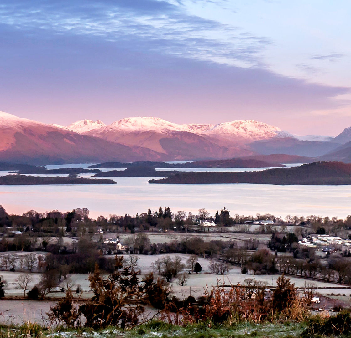 Winter Loch Lomond view with a background of Luss Hills, Arrochar Hills and Ben Lomond. Some of the best winter walks in Scotland.