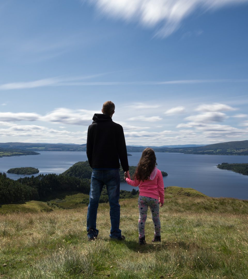 Father and Daughter looking out over loch lomond