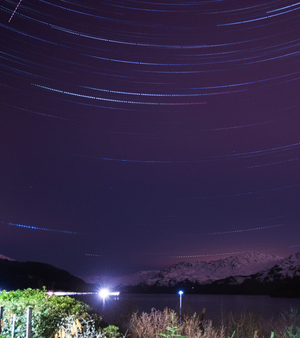 Long exposure photograph showing the stars over Loch Lomond