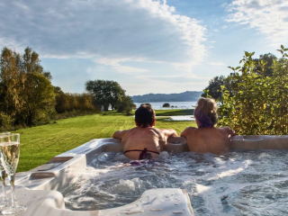 Hot-Tub-Looking-Out-At-Loch-Lomond two women in a hot tub looking out at loch lomond