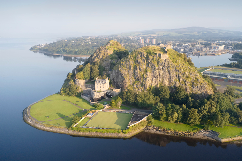 Dumbarton castle building on volcanic rock aerial view from above Scotland.