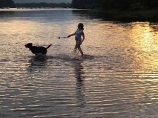 Dog and owner in water at Loch Lomond Waterfront