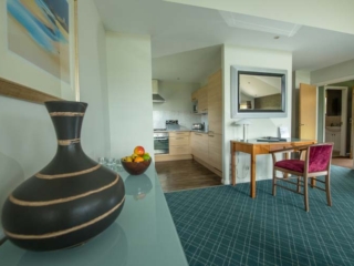 An open plan living area  in a chalet at Loch Lomond Waterfront