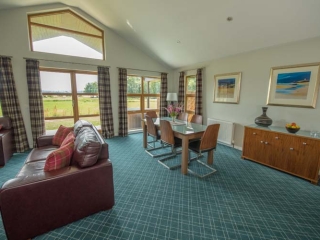 A dining area  in a chalet at Loch Lomond Waterfront