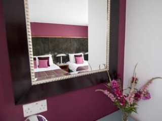 Beds reflecting in a mirror  in a chalet at Loch Lomond Waterfront