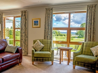 A lounge with a view in a lodge at Loch Lomond Waterfront A lounge with a view in a lodge at Loch Lomond Waterfront