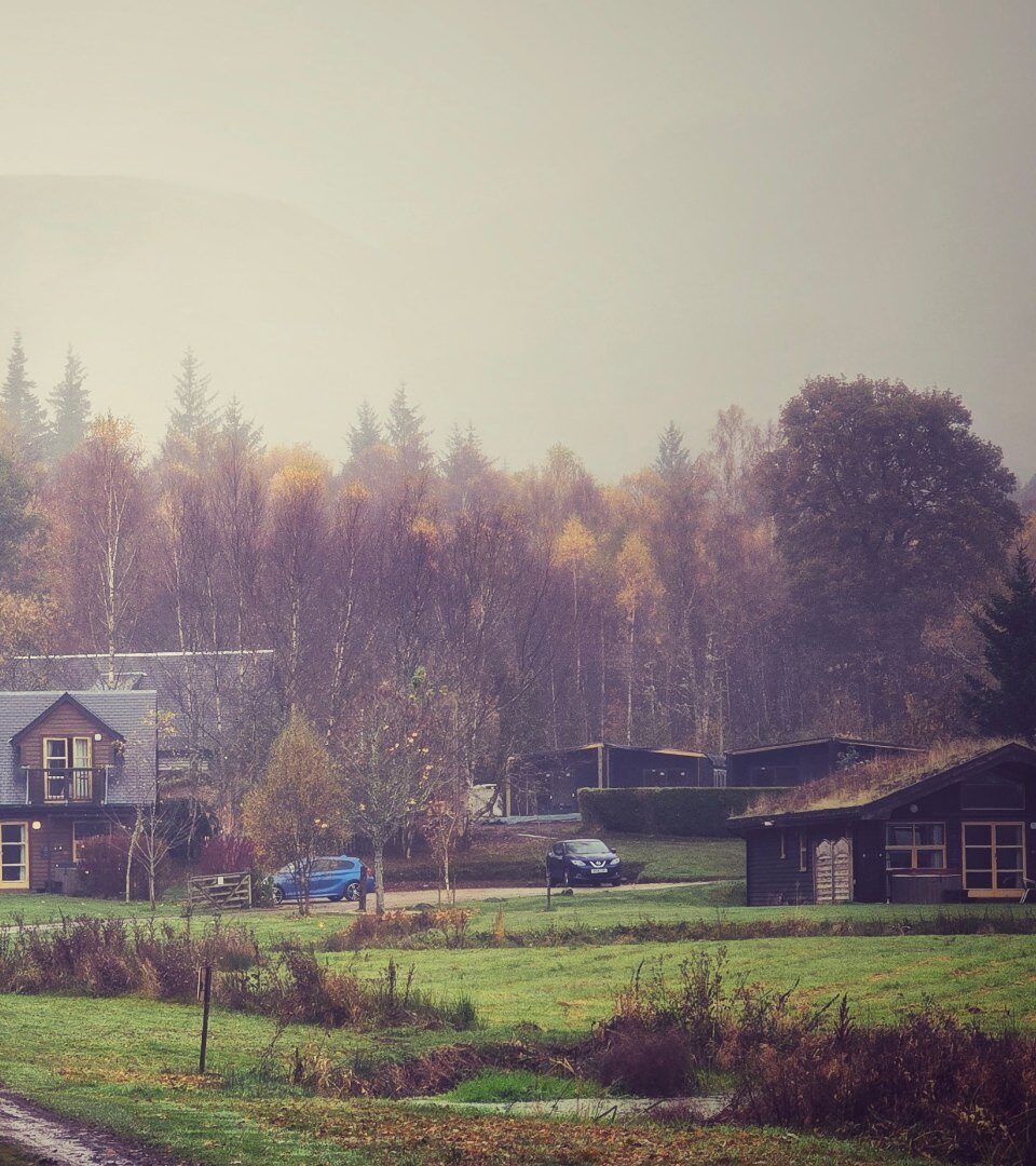 A Loch Lomond Waterfront cabins on a rainy day in Autumn with beautiful colours.