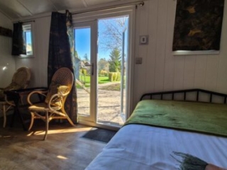 The view outside through the double doors from the bed in a Shepherd&#039;s Hut at Loch Lomond Waterfront
