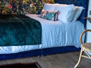 A double bed in a Shepherd&#039;s Hut at Loch Lomond Waterfront