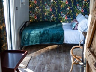 The sleeping and sitting area in a Shepherd&#039;s Hut at Loch Lomond Waterfront