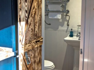 The entrance to the bathroom in a Shepherd&#039;s Hut at Loch Lomond Waterfront