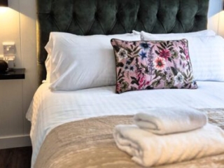 A double bed in a Studio Lodge at Loch Lomond Waterfront