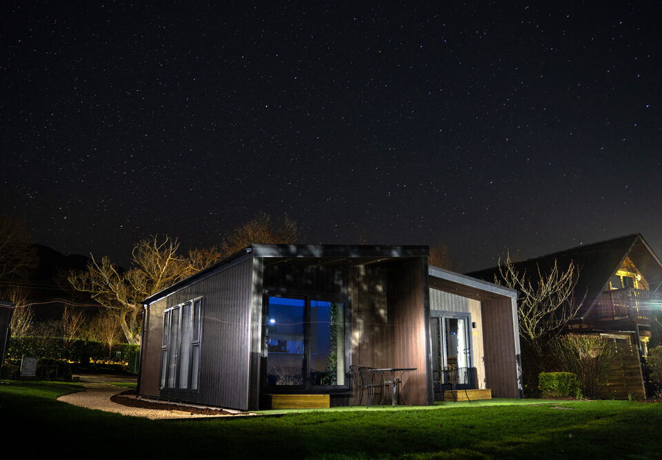 A Studio Lodge at Loch Lomond Waterfront lit up at night