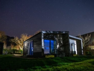 A Studio Lodge at Loch Lomond Waterfront lit up at night