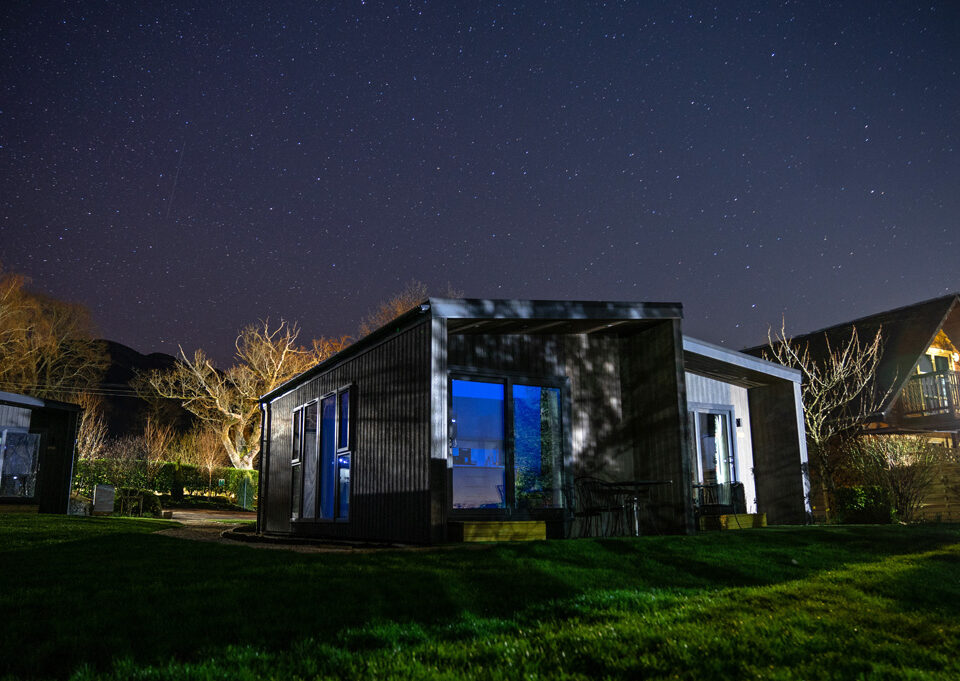 A Studio Lodge at Loch Lomond Waterfront lit up at night