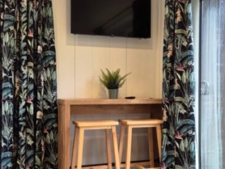 The TV and sitting are in a Studio Lodge at Loch Lomond Waterfront