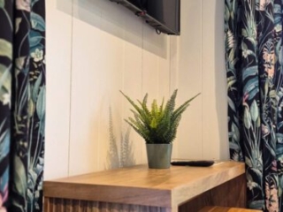 The TV and a breakfast bar Studio Lodge at Loch Lomond Waterfront