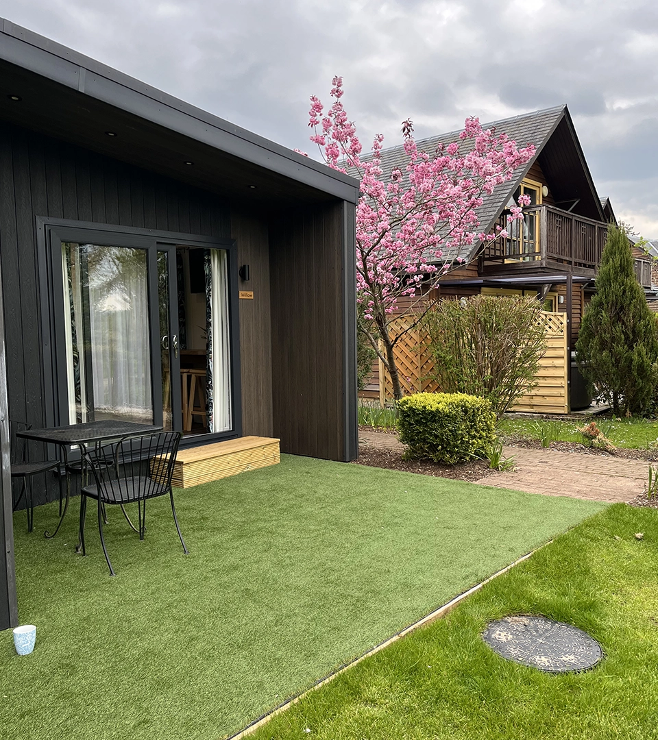 The outdoor terrace and a Cherry Tree in bloom at a Studio Cabin at Loch Lomond Waterfront