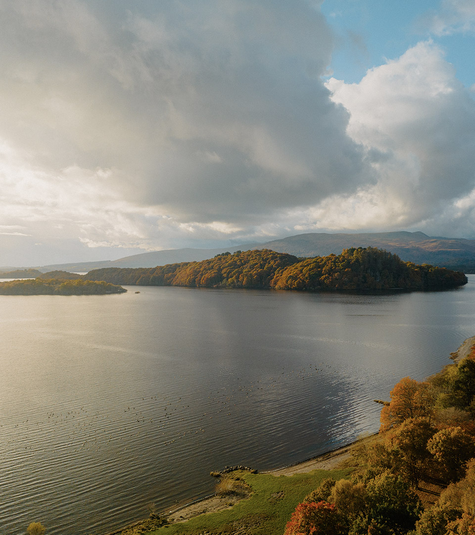 A romantic view over Loch Lomond with the private beach belonging to Loch Lomond Waterfront