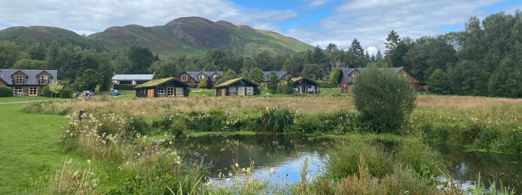 The stunning resort of Loch Lomond Waterfront with the iconic Conic Hill in the background