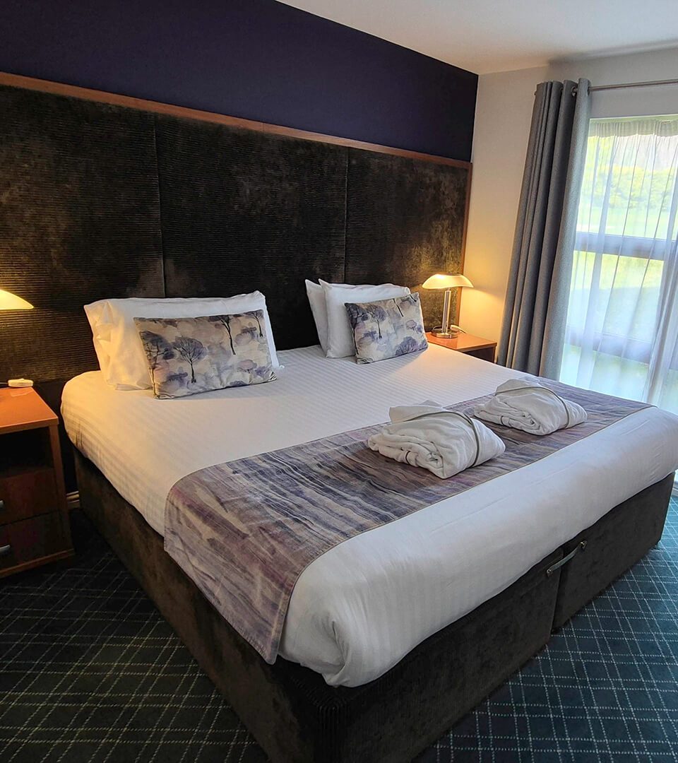 A double bed in a bright Self Catering Chalet at Loch Lomond Waterfront
